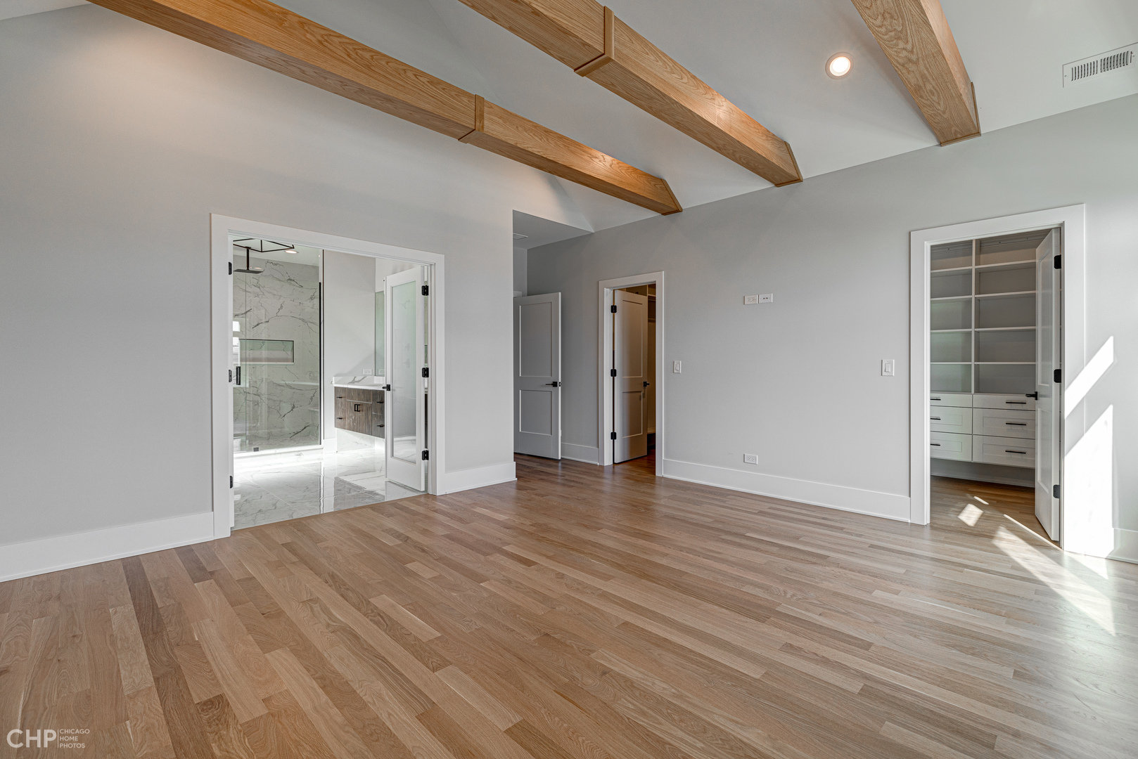 3711 North Spaulding Avenue Chicago, IL 60618 - Photo 18 of 35 a view of an empty room with wooden floor and a window