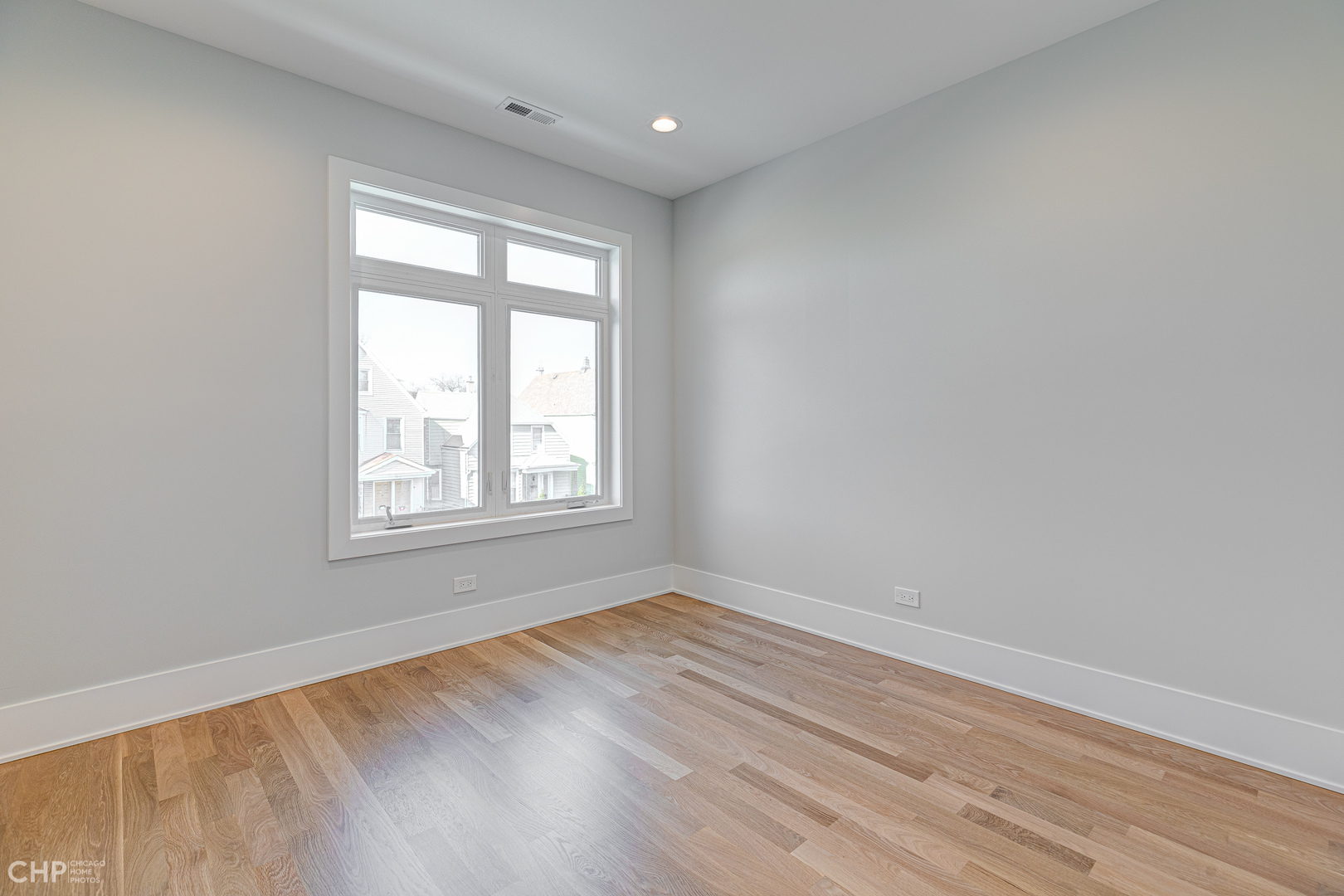 3711 North Spaulding Avenue Chicago, IL 60618 - Photo 24 of 35 wooden floor in an empty room with a window