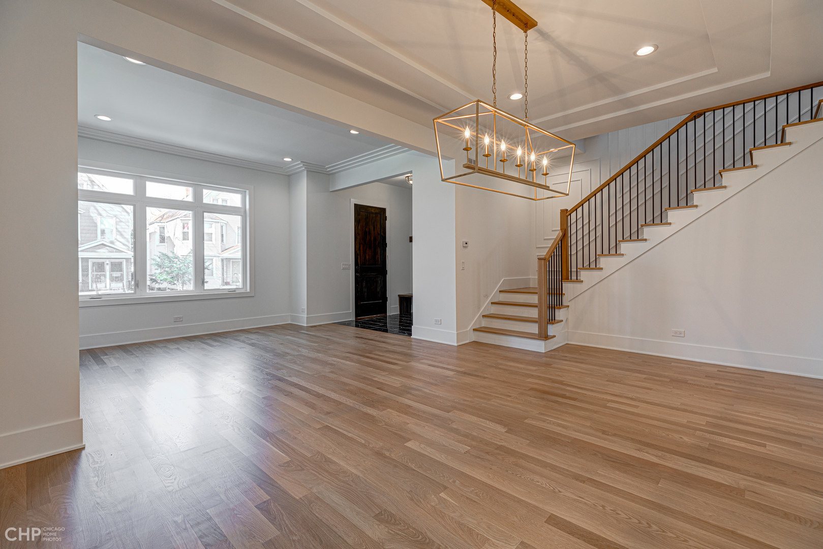 3711 North Spaulding Avenue Chicago, IL 60618 - Photo 7 of 35 a view of an empty room with wooden floor and a window