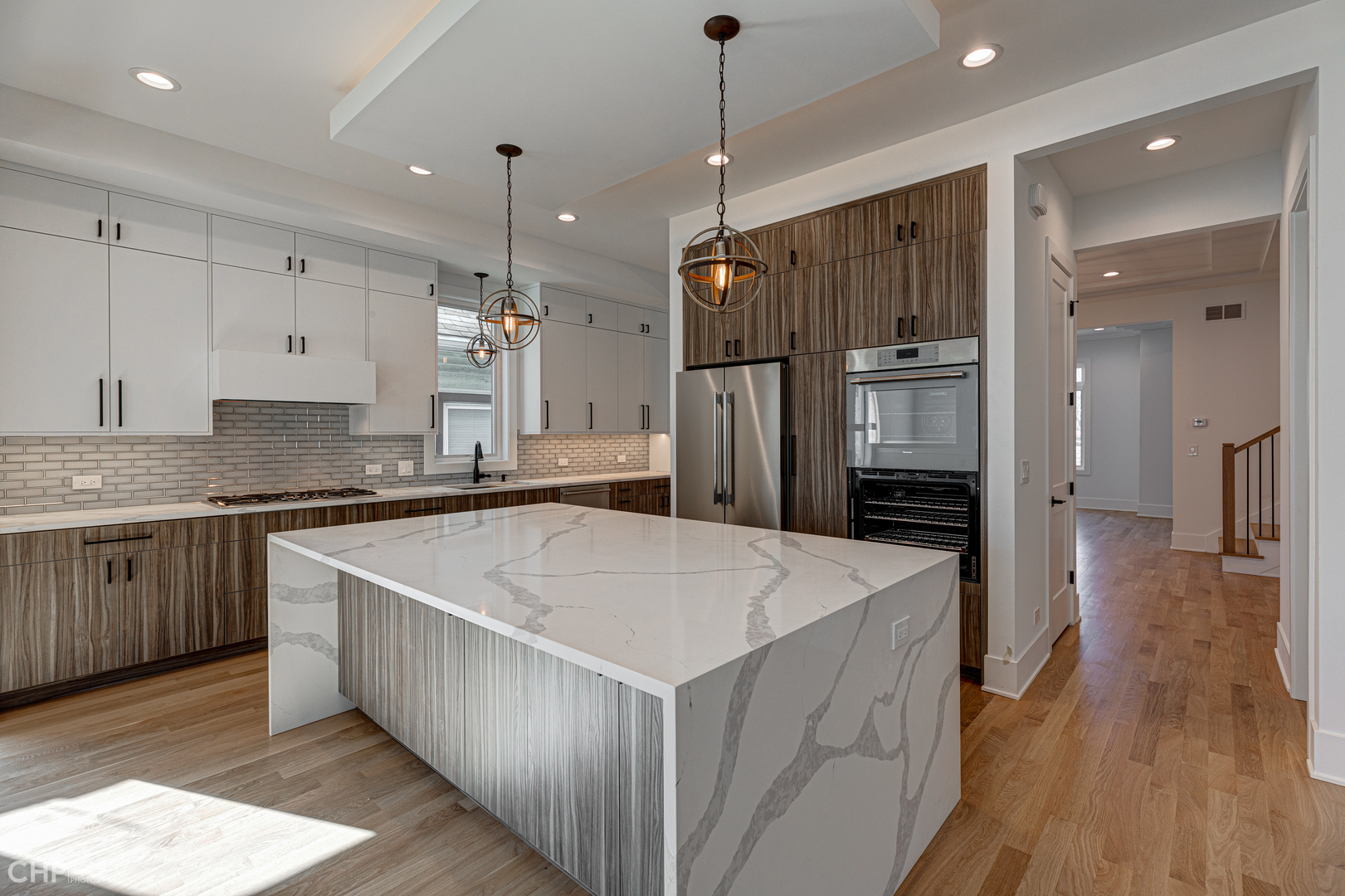 3711 North Spaulding Avenue Chicago, IL 60618 - Photo 8 of 35 a kitchen with stainless steel appliances kitchen island granite countertop a refrigerator a sink and wooden floor