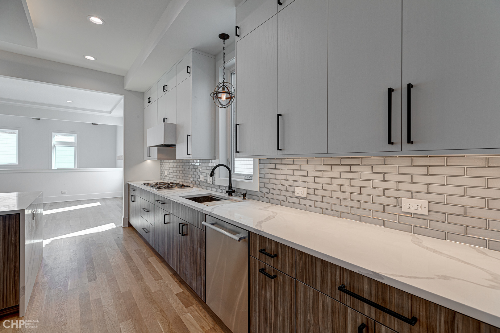 3711 North Spaulding Avenue Chicago, IL 60618 - Photo 9 of 35 a kitchen with sink cabinets and wooden floor