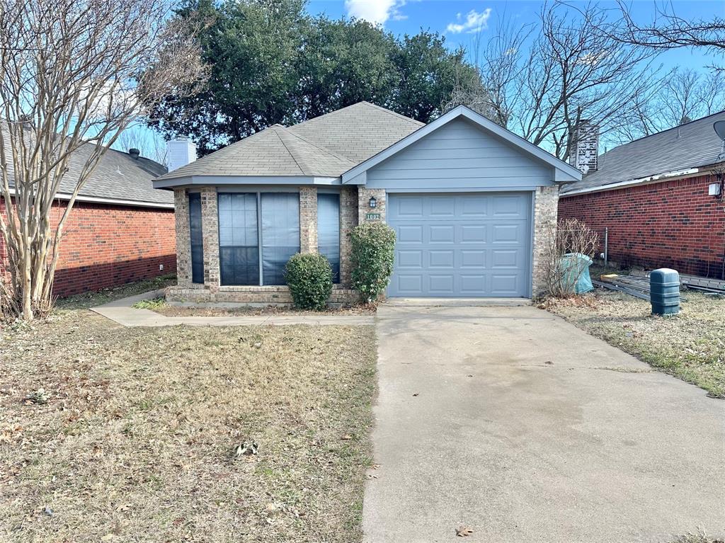 1002 Bull Run Street Denton, TX 76209 - Photo 1 of 21 a front view of a house with a yard and garage