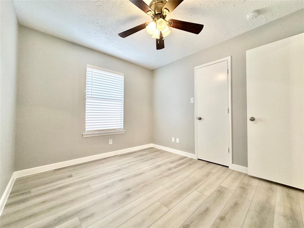 1002 Bull Run Street Denton, TX 76209 - Photo 14 of 21 a view of an empty room with window and wooden floor