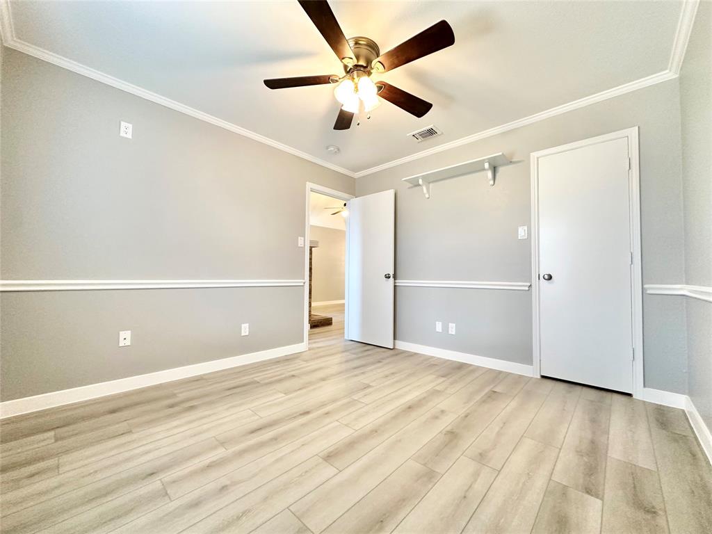 1002 Bull Run Street Denton, TX 76209 - Photo 19 of 21 wooden floor in an empty room with a ceiling fan