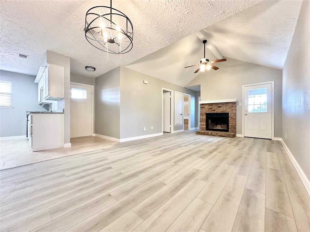 1002 Bull Run Street Denton, TX 76209 - Photo 3 of 21 a view of empty room with a fireplace and fan