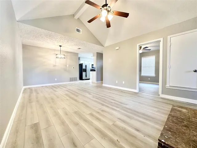 a view of a room with wooden floor