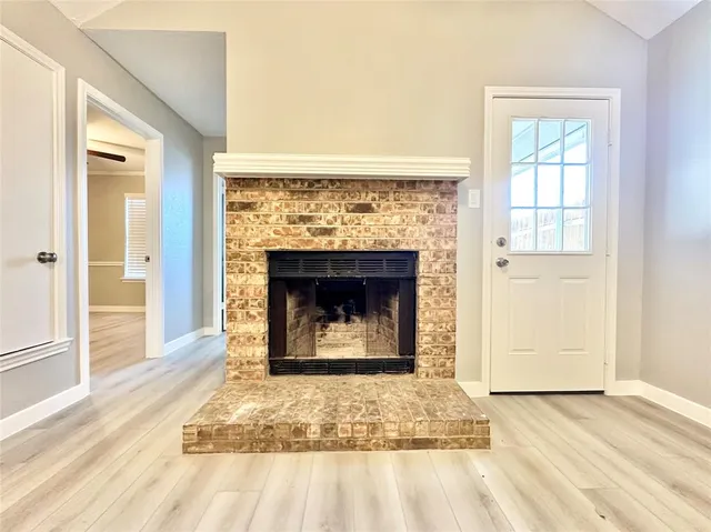 a living room with a fireplace and a rug