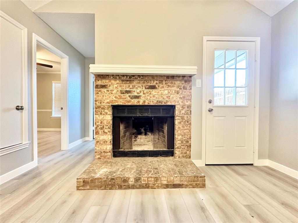 1002 Bull Run Street Denton, TX 76209 - Photo 5 of 21 a living room with a fireplace and a rug