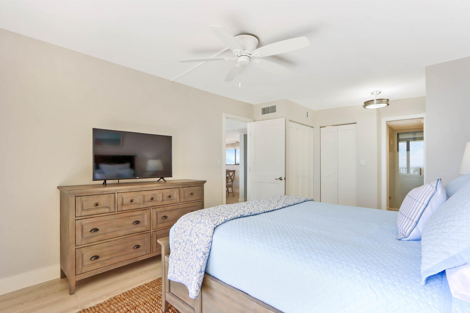 200 Ocean Trail Way, Unit 305 Jupiter, FL 33477 - Photo 11 of 27 a bedroom with a bed and flat screen tv
