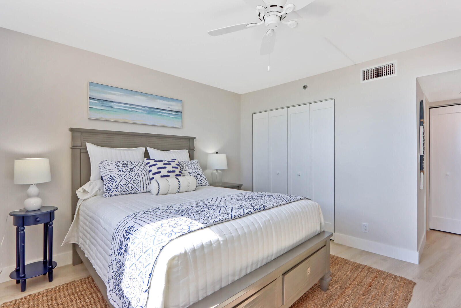 200 Ocean Trail Way, Unit 305 Jupiter, FL 33477 - Photo 12 of 27 a bedroom with a bed and a chandelier
