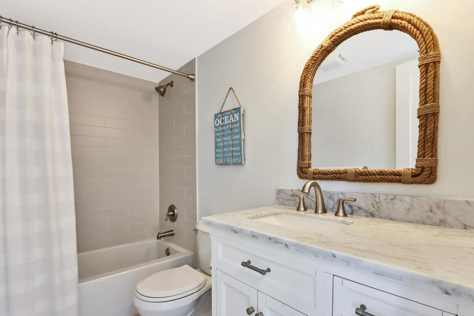 200 Ocean Trail Way, Unit 305 Jupiter, FL 33477 - Photo 14 of 27 a bathroom with a granite countertop sink a mirror a vanity and a shower