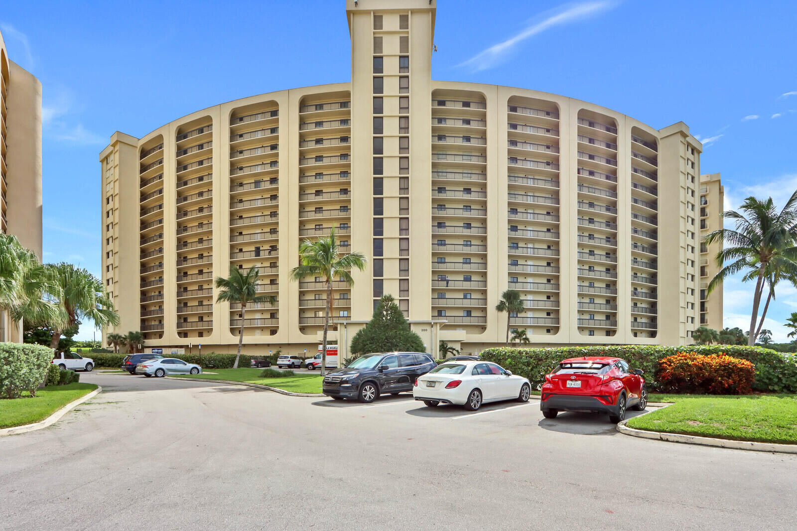 200 Ocean Trail Way, Unit 305 Jupiter, FL 33477 - Photo 19 of 27 a car parked in front of a building