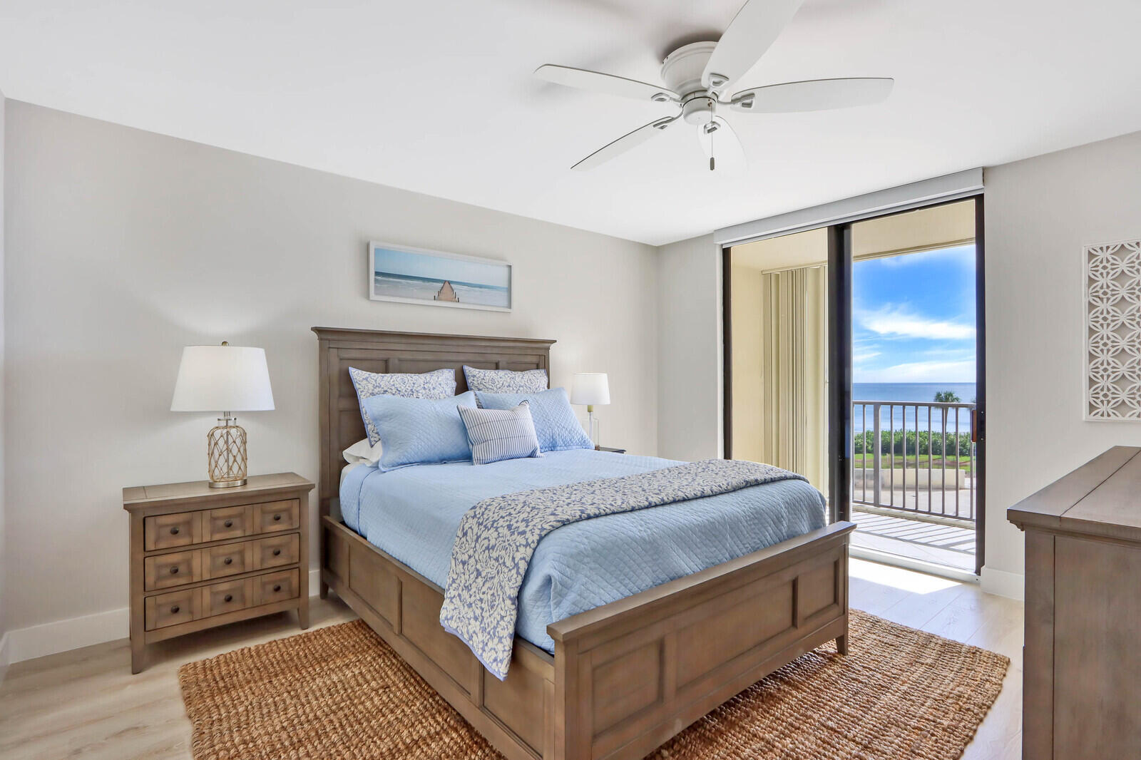 200 Ocean Trail Way, Unit 305 Jupiter, FL 33477 - Photo 8 of 27 a bedroom with a large bed and a chandelier