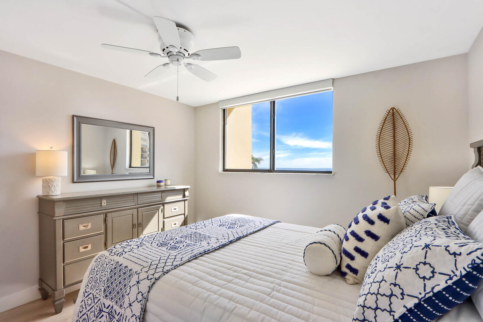 200 Ocean Trail Way, Unit 305 Jupiter, FL 33477 - Photo 10 of 27 a bedroom with a large bed and a chandelier