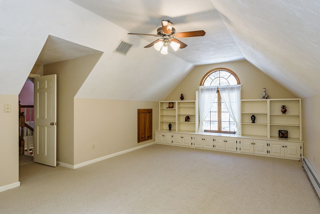 266 Sargent Road Boxborough, MA 01719 - Photo 11 of 15 an empty room with windows and chandelier fan