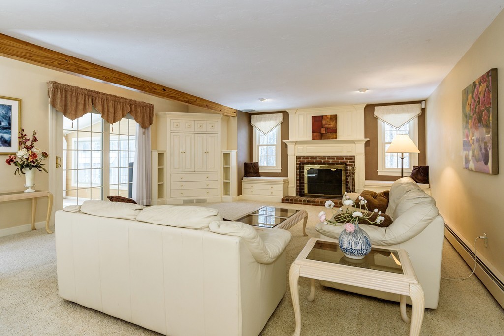 266 Sargent Road Boxborough, MA 01719 - Photo 2 of 15 a living room with furniture a fireplace and a flat screen tv