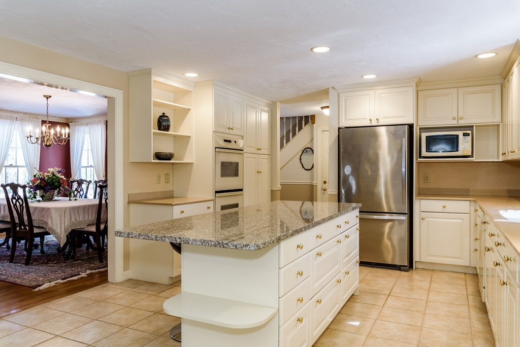 266 Sargent Road Boxborough, MA 01719 - Photo 5 of 15 a kitchen with stainless steel appliances kitchen island granite countertop a refrigerator and a sink