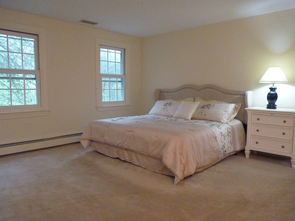 266 Sargent Road Boxborough, MA 01719 - Photo 10 of 15 a spacious bedroom with a bed and window