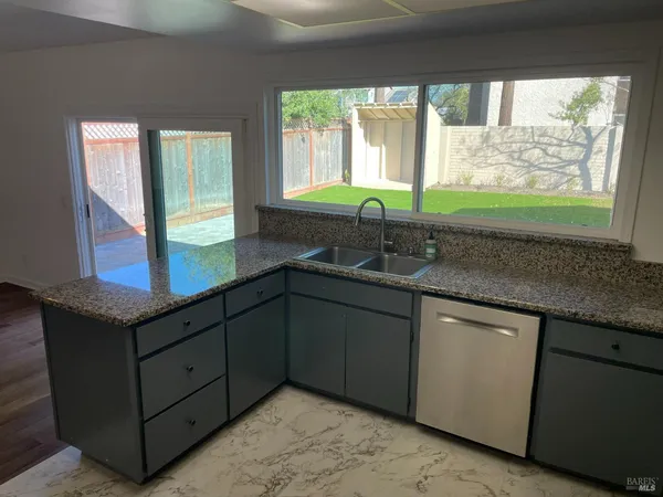 a kitchen with a sink and a large window