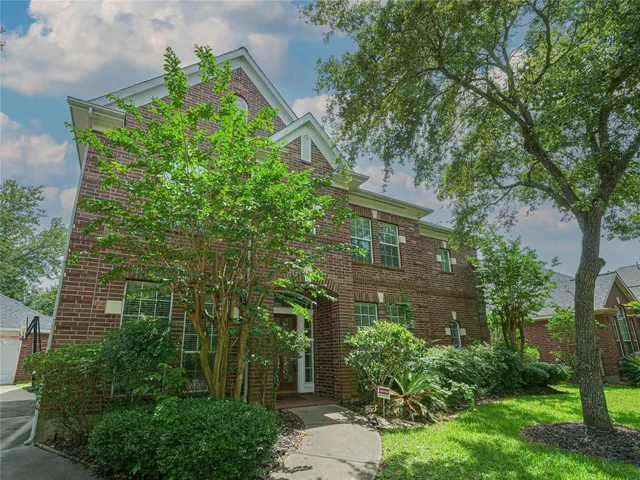 front view of a house with a tree