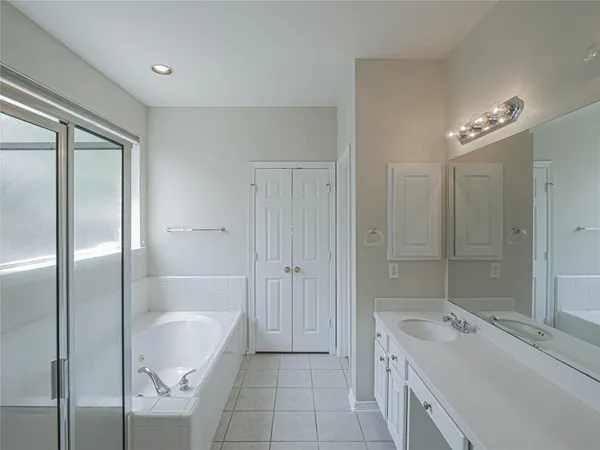 a spacious bathroom with a granite countertop sink a toilet and shower
