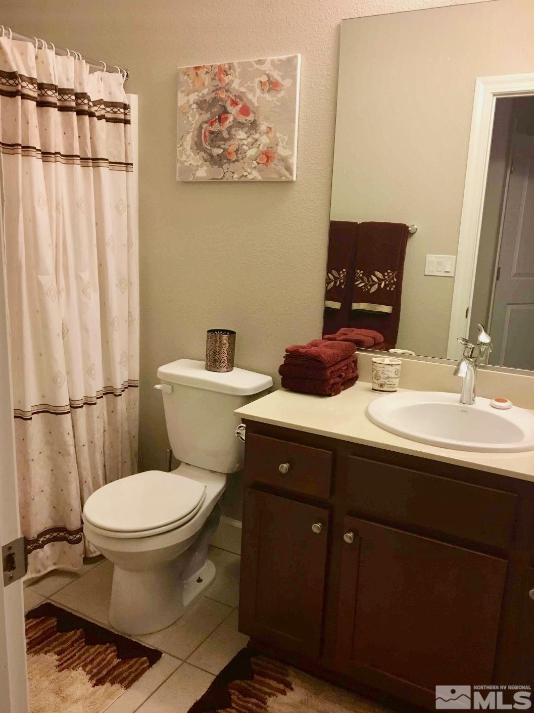 2037 Wind Ranch Road, Unit B Reno, NV 89521 - Photo 11 of 21 a bathroom with a sink toilet and shower