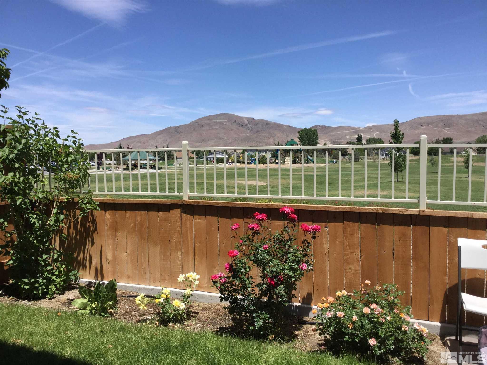 2037 Wind Ranch Road, Unit B Reno, NV 89521 - Photo 20 of 21 a view of a lake with a house in the background