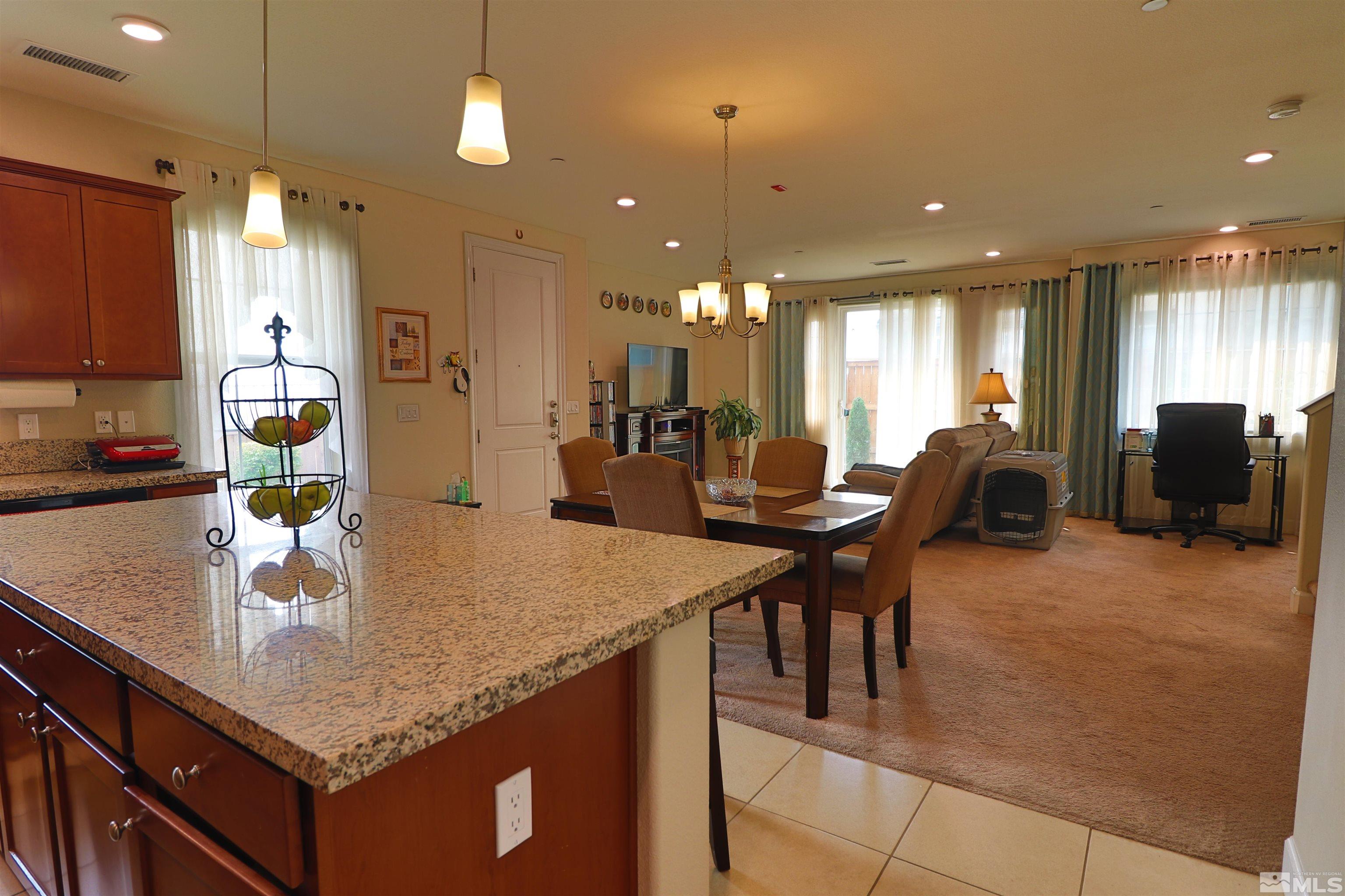 2037 Wind Ranch Road, Unit B Reno, NV 89521 - Photo 6 of 21 a kitchen with center island table and chairs