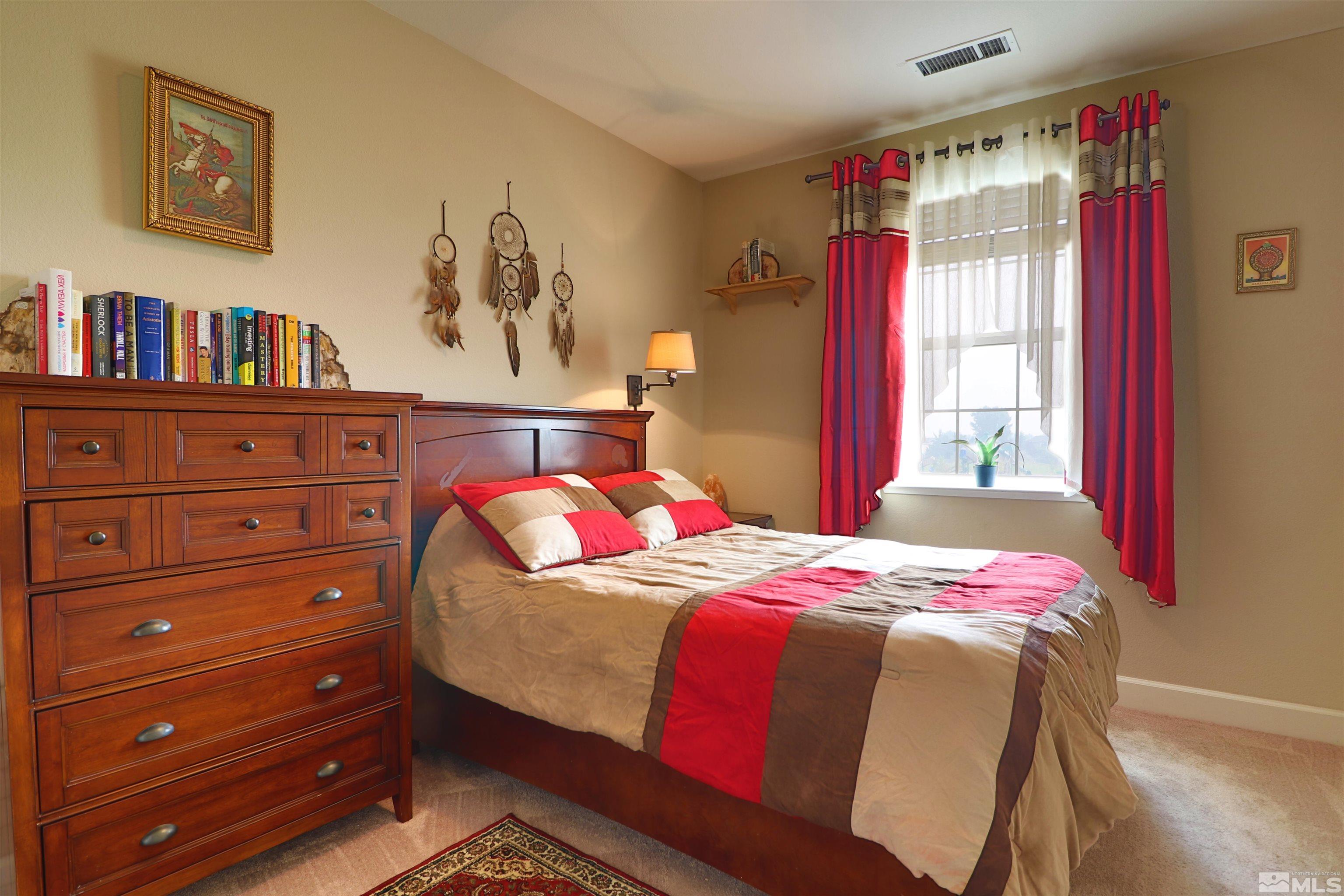 2037 Wind Ranch Road, Unit B Reno, NV 89521 - Photo 8 of 21 a bedroom with a bed and a window