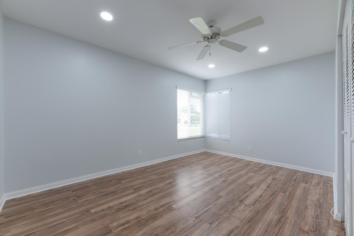4695 Brandywine Drive Boca Raton, FL 33487 - Photo 16 of 28 an empty room with wooden floor and ceiling fan