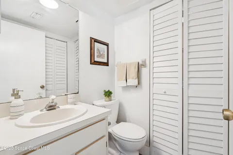 a view of a house with a yard and palm trees