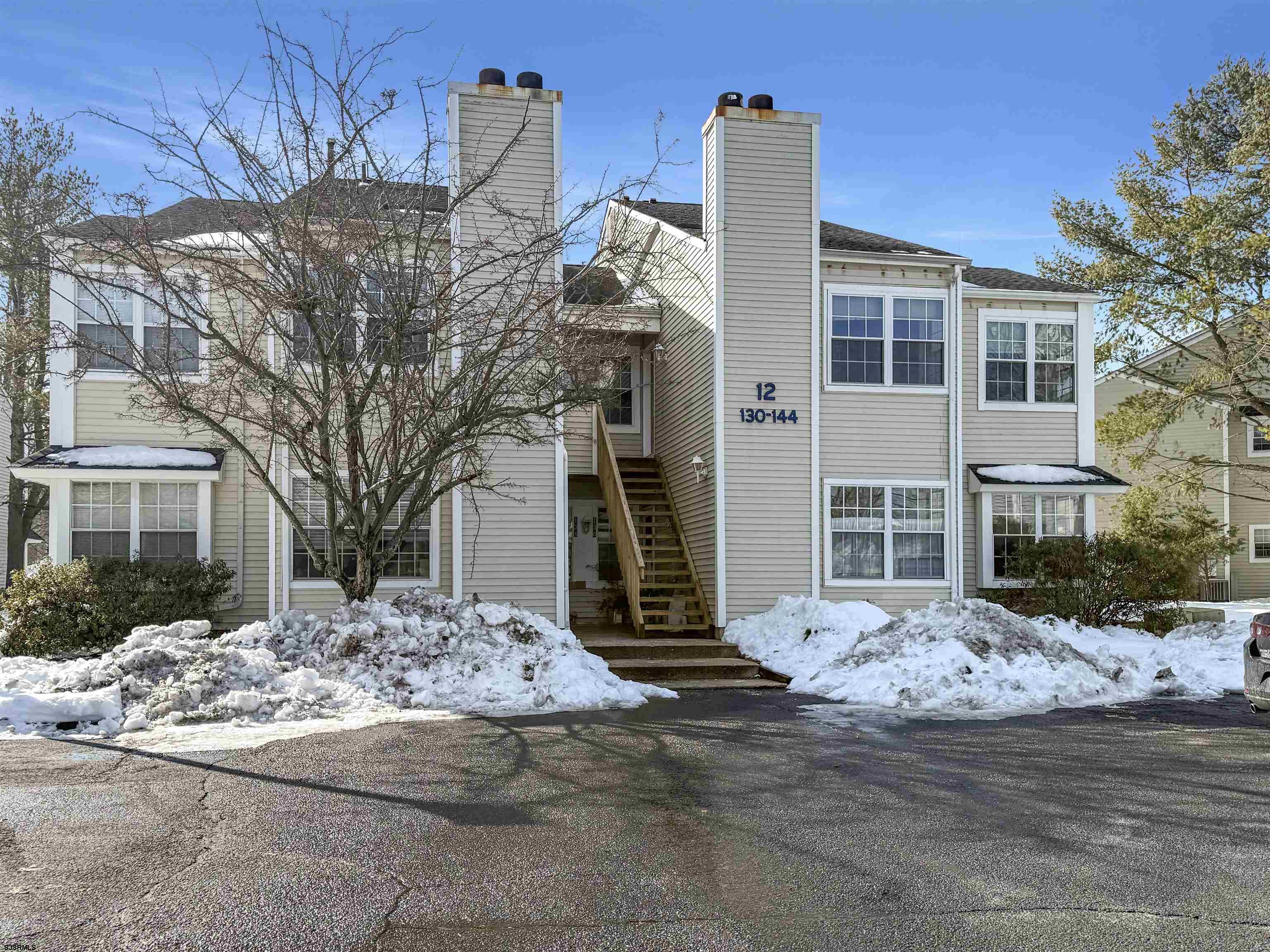 132 Meadow Ridge Road, Unit 132 Smithville, NJ 08205 - Photo 3 of 7 a front view of a building with a tree