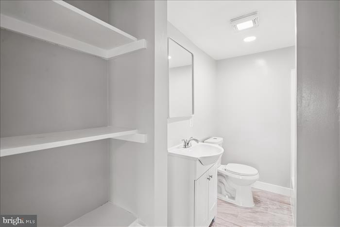 501-503 8th Street Laurel, MD 20707 - Photo 67 of 86 a bathroom with a toilet a sink and mirror