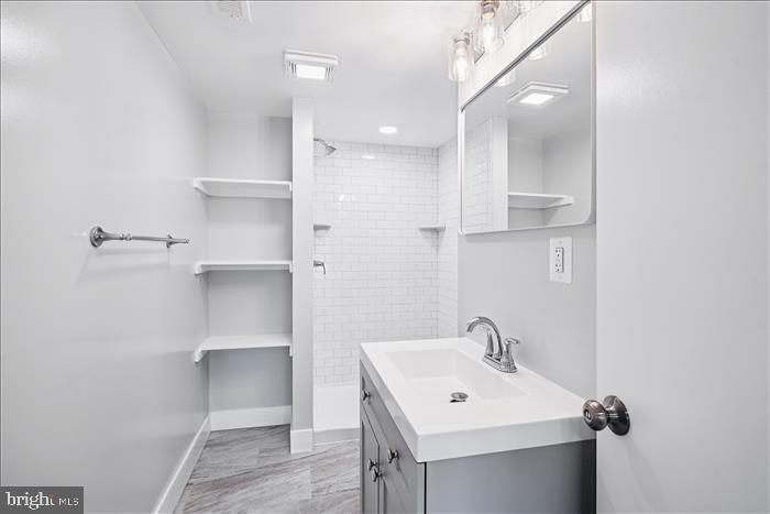 501-503 8th Street Laurel, MD 20707 - Photo 73 of 86 a bathroom with a sink a toilet and mirror