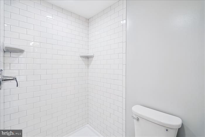 501-503 8th Street Laurel, MD 20707 - Photo 74 of 86 a white toilet sitting next to a shower