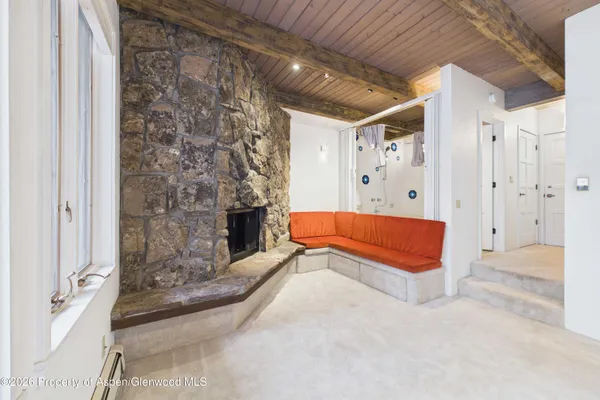 a spacious bedroom with a bed and a fireplace