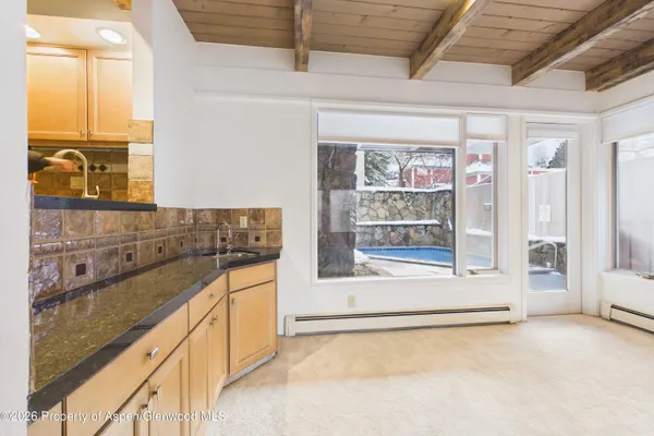 a view of a refrigerator a sink and a window