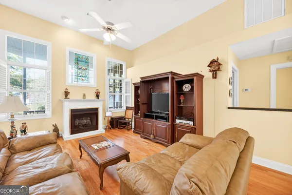 a living room with furniture fireplace and flat screen tv