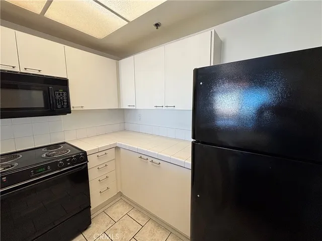 a view of a hallway with wooden floor and a window