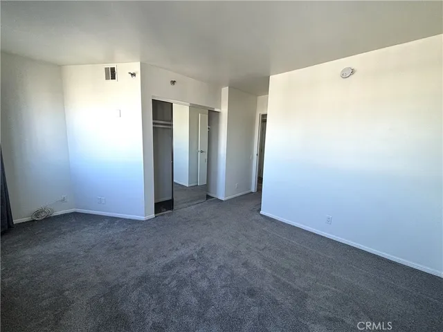 a bathroom with a granite countertop sink toilet a mirror and shower