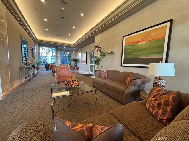 a living room with furniture and a dining table with kitchen view