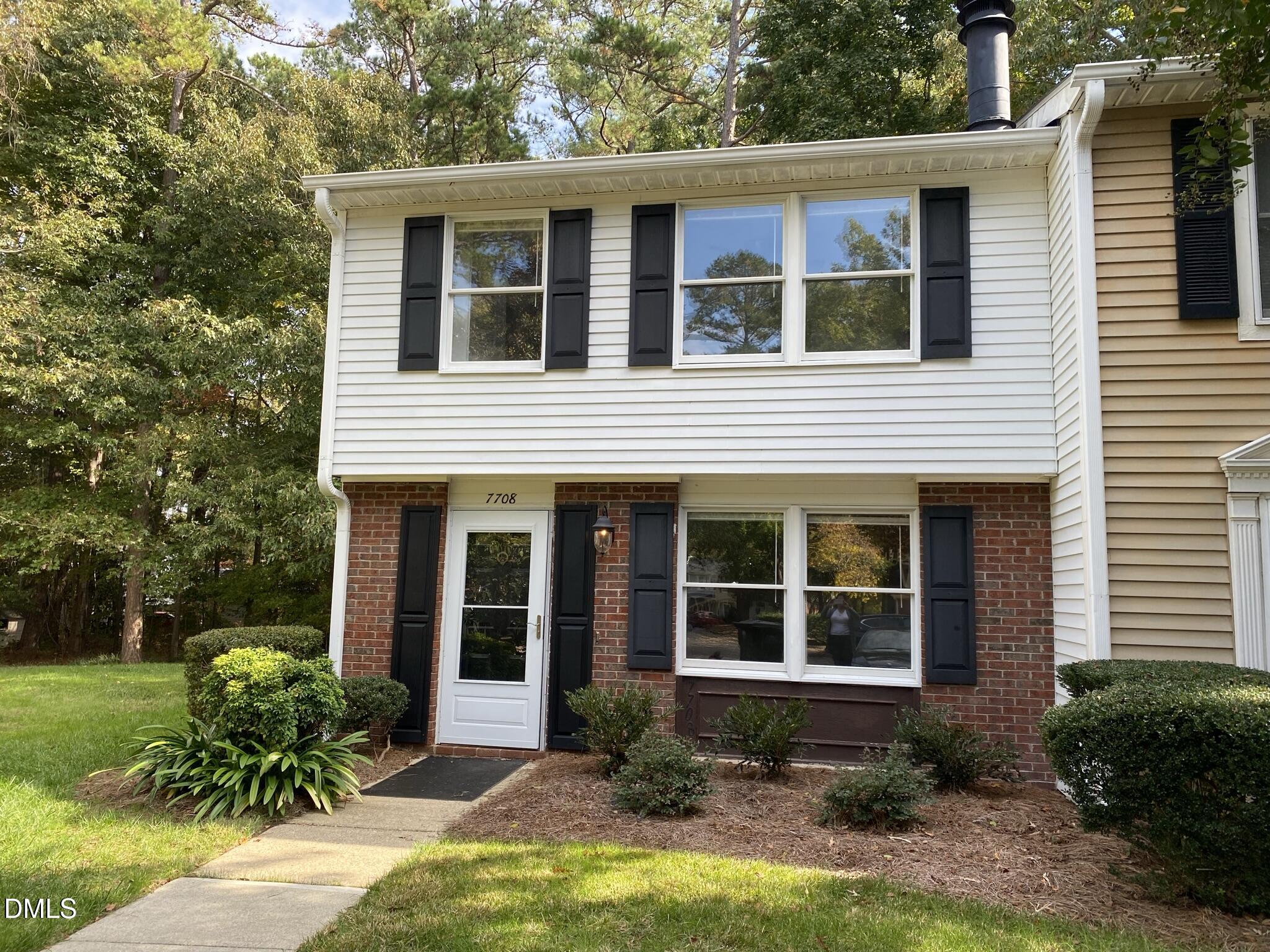 a front view of a house with garden and porch