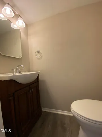 a bathroom with a sink vanity and a toilet