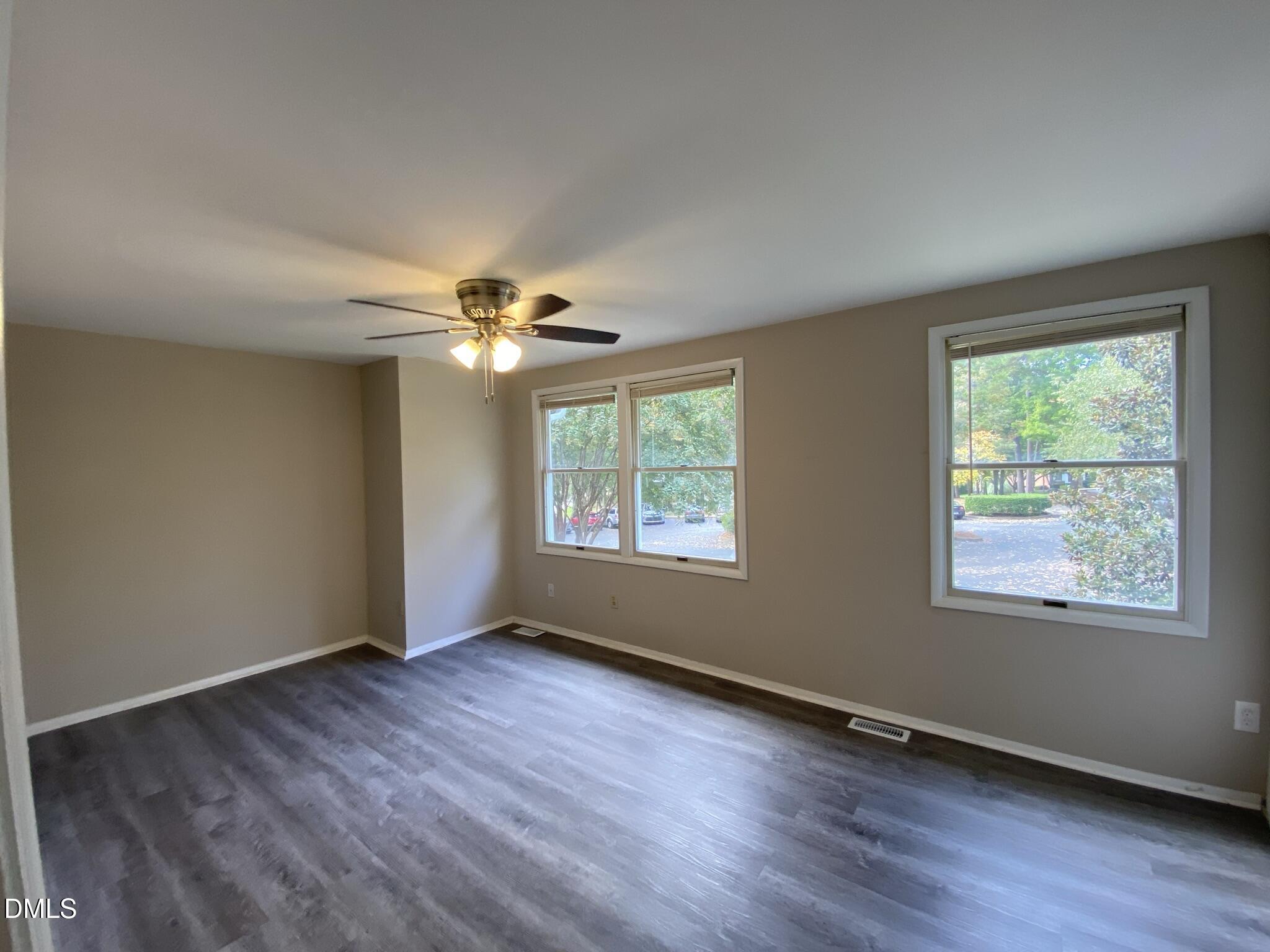 7708 Crown Crest Court Raleigh, NC 27615 - Photo 14 of 27 a view of an empty room with wooden floor and a window