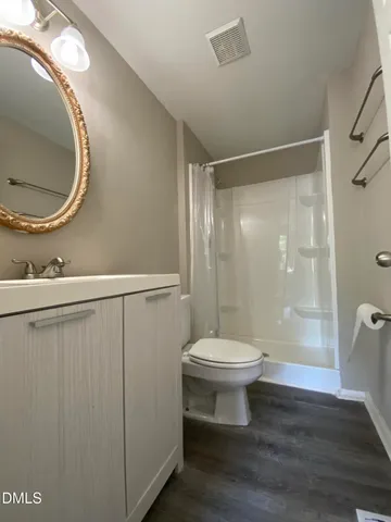 a bathroom with a toilet and a mirror