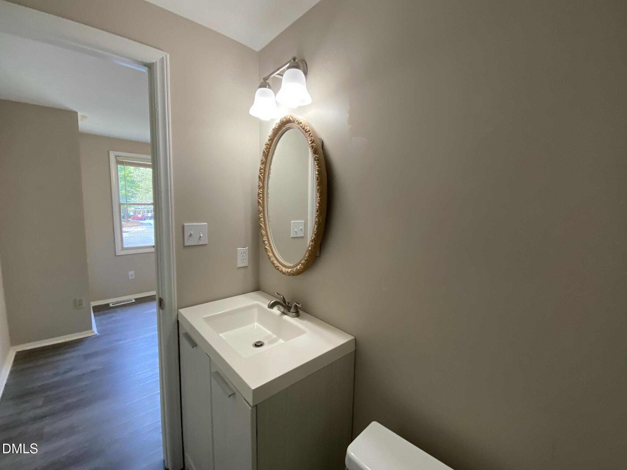 7708 Crown Crest Court Raleigh, NC 27615 - Photo 17 of 27 a bathroom with a sink and a mirror
