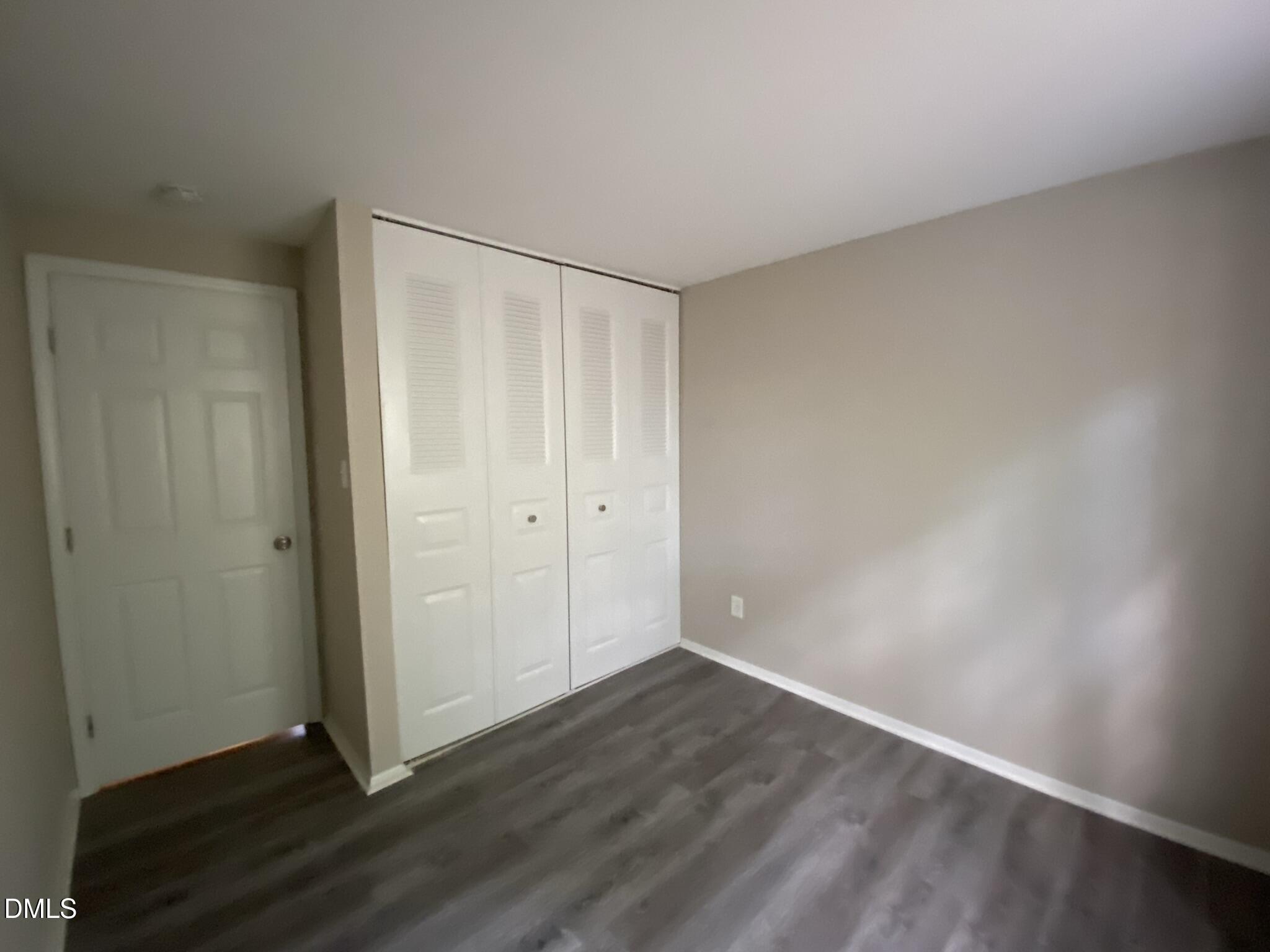 7708 Crown Crest Court Raleigh, NC 27615 - Photo 18 of 27 a view of an empty room with wooden floor