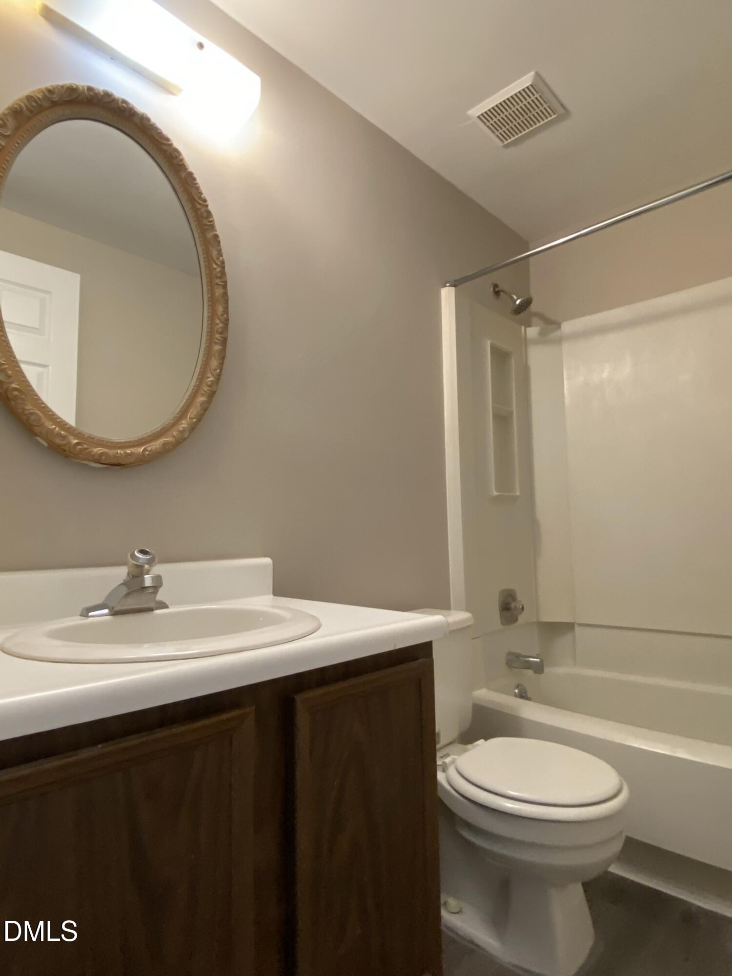 7708 Crown Crest Court Raleigh, NC 27615 - Photo 19 of 27 a bathroom with a sink a toilet and a mirror
