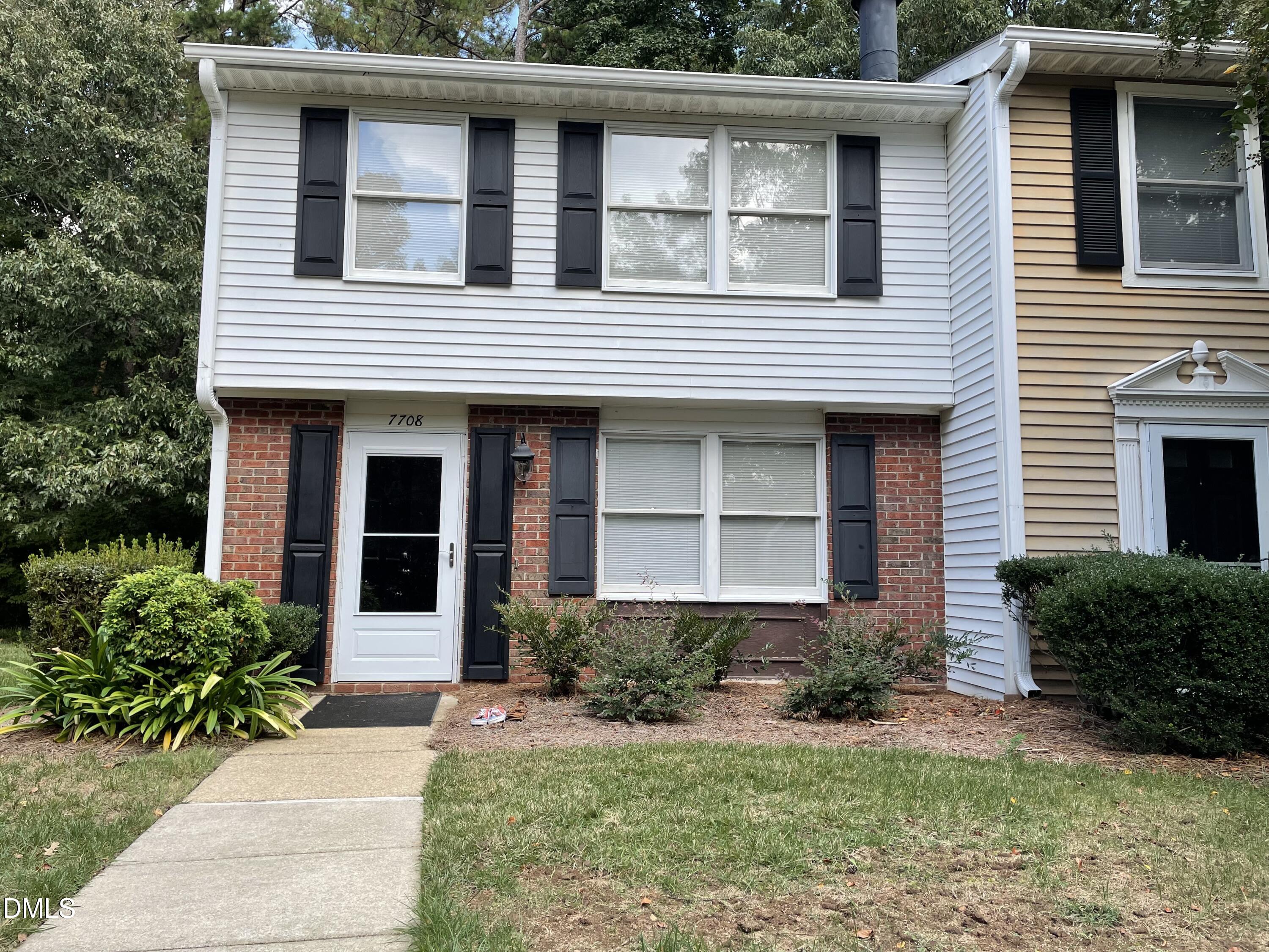 7708 Crown Crest Court Raleigh, NC 27615 - Photo 2 of 27 a front view of a house with garden