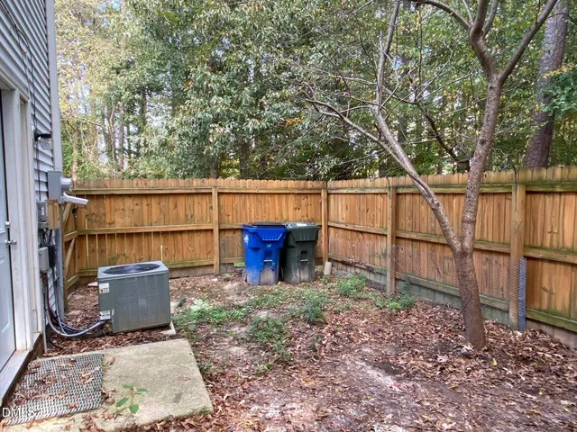 a view of backyard with outdoor seating and barbeque oven
